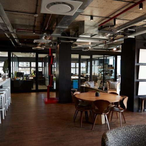 Bar and dining area in the office of a creative business, in daylight, no people